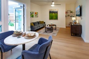 Canoga Park apartment for rent - A dining room with a round table and blue chairs.