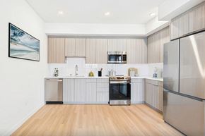 San Pedro apartment for rent - A modern kitchen with stainless steel appliances and wooden flooring.