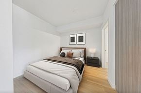 San Pedro apartment for rent - A bedroom with a large bed and two nightstands.