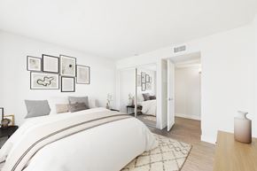 Burbank apartment for rent - A white bedroom with a large bed and pictures on the wall.
