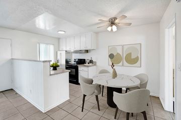 Reseda apartment for rent - A white kitchen with a table and chairs.