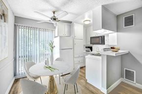 North Hollywood apartment for rent - an open kitchen and dining room with a white table and chairs