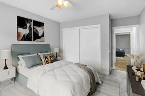 North Hollywood apartment for rent - a bedroom with a large bed and a ceiling fan