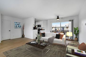 Los Angeles apartment for rent - A modern living room with a glass coffee table and a white sofa.