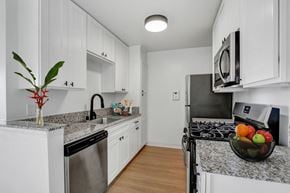 Los Angeles apartment for rent - a kitchen with white cabinetry and granite countertops