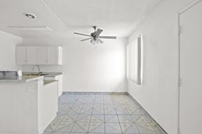 Westminster apartment for rent - an empty kitchen with white cabinets and a ceiling fan