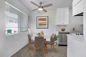 Los Angeles apartment for rent - a dining area with a table and chairs and a ceiling fan