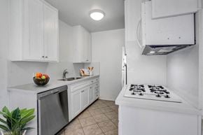 Los Angeles apartment for rent - a kitchen with white cabinetry and a white stove top oven