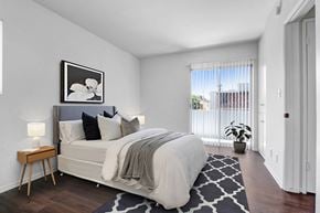 Los Angeles apartment for rent - a bedroom with a large bed and a large window