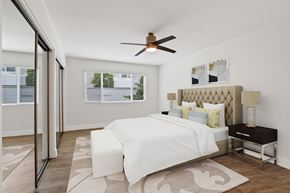 Newport Beach apartment for rent - A bedroom with a large bed and a ceiling fan.