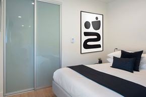 Los Angeles apartment for rent - a bedroom with a bed and a glass door at The Aster, Los Angeles, CA, 90024