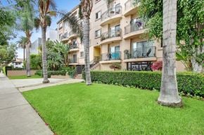 Los Angeles apartment for rent - A building with balconies and a tree in front.