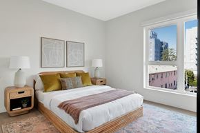 Los Angeles apartment for rent - a bedroom with a large window and a large bed with a white comforter