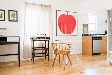 Los Angeles apartment for rent - A kitchen with a table and chairs and a framed picture of an apple on the wall.