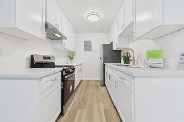 Arleta apartment for rent - A kitchen with white cabinets and appliances.