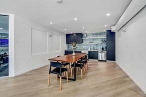 Encino apartment for rent - a dining area with a wooden table and chairs and a kitchen in the background