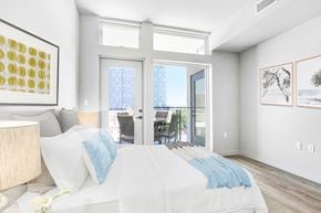 Los Angeles apartment for rent - a bedroom with a bed and sliding glass doors to a balcony