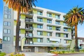 Los Angeles apartment for rent - a large apartment building with palm trees in front of it