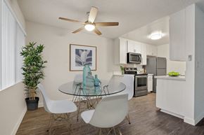 Los Angeles apartment for rent - A dining room with a glass table and white chairs.