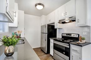 Los Angeles apartment for rent - A kitchen with white cabinets and a black refrigerator.