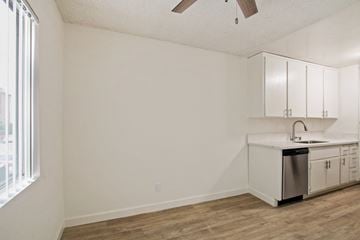 Los Angeles apartment for rent - A kitchen with white cabinets and a wooden floor.