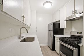 Los Angeles apartment for rent - A kitchen with a black fridge and stove.