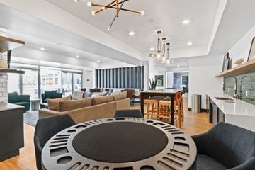 Bellflower apartment for rent - A modern living room with a large circular coffee table in the center.