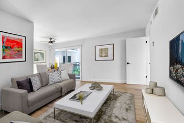 Los Angeles apartment for rent - A living room with a grey couch, a white coffee table, and a painting on the wall.
