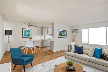 Culver City apartment for rent - A living room with a blue chair and a white couch.
