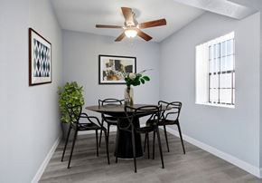 North Hollywood apartment for rent - a dining room with a table and chairs and a ceiling fan