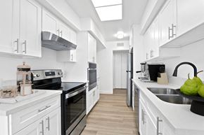 Los Angeles apartment for rent - a white kitchen with black appliances and white cabinets