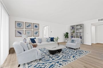 Los Angeles apartment for rent - A living room with a white couch and a blue patterned rug.