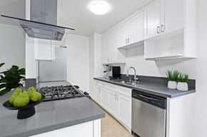 Beverly Hills apartment for rent - a white kitchen with stainless steel appliances and white cabinets