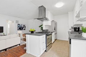 Beverly Hills apartment for rent - a kitchen with white cabinets and a stove top oven