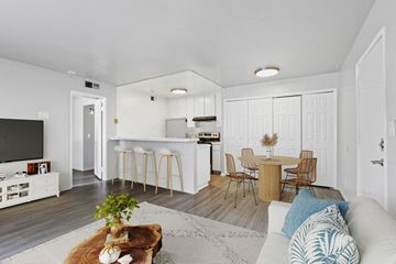 Tarzana apartment for rent - A modern living room with a white couch and a wooden coffee table.