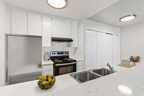 Tarzana apartment for rent - a white kitchen with stainless steel appliances and a counter top