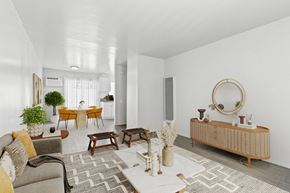 Canoga Park apartment for rent - a living room with a couch and a table and a mirror