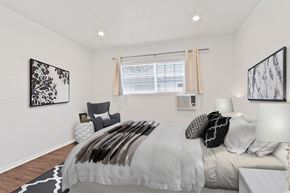 Los Angeles apartment for rent - A bedroom with a large bed and two lamps.