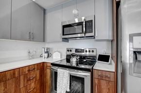 Reseda apartment for rent - a kitchen with stainless steel appliances and a microwave