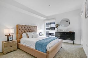 Reseda apartment for rent - a bedroom with a bed and a dresser and a window