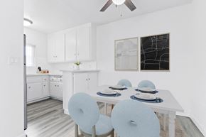 Los Angeles apartment for rent - a white kitchen with a white table and blue chairs