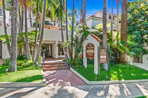 West Hollywood apartment for rent - a house with palm trees and a sign in front of it