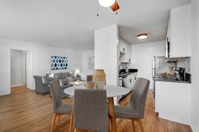 Studio City apartment for rent - A modern dining room with a white table and grey chairs.