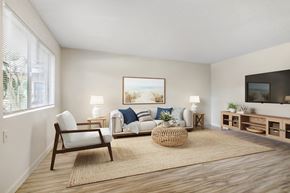 Ventura apartment for rent - A living room with a sofa, chair, and a painting on the wall.