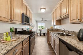 West Hollywood apartment for rent - a kitchen with wooden cabinets and granite counter tops