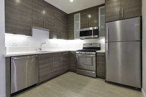 Santa Monica apartment for rent - a kitchen with stainless steel appliances and wooden cabinets at Seventh West Apartments, Santa Monica 