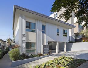 Los Angeles apartment for rent - a white building with a sign in front of it