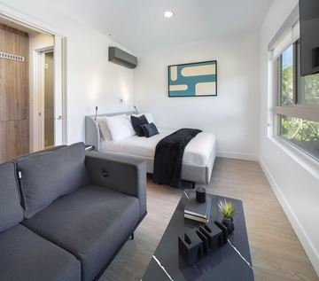 Los Angeles apartment for rent - A modern living room with a grey couch and a black coffee table.