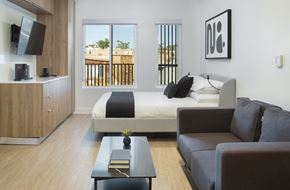 Los Angeles apartment for rent - a bedroom with a bed and a couch and a coffee table