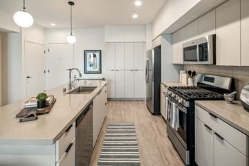 Inglewood apartment for rent - a kitchen with stainless steel appliances and white cabinets